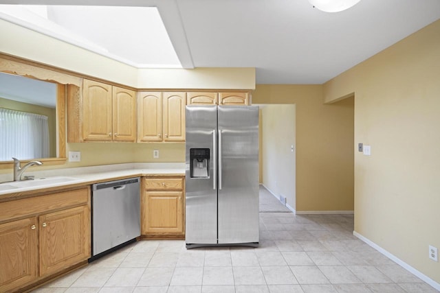 8074 48th Ave, Kenosha, WI 53142 - kitchen with appliances with stainless steel finishes, light countertops, light tile patterned floors, and light brown cabinetry