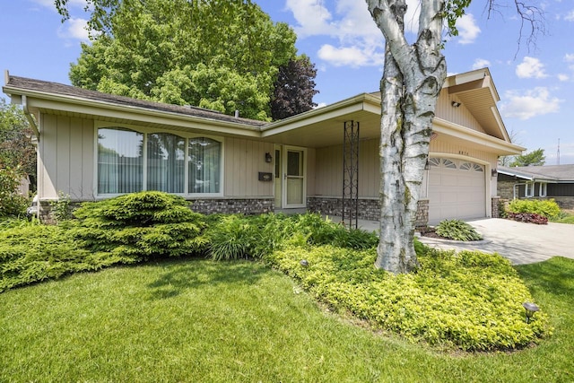 8074 48th Ave, Kenosha, WI 53142 - view of front of home featuring stone siding, driveway, a front yard, and a garage