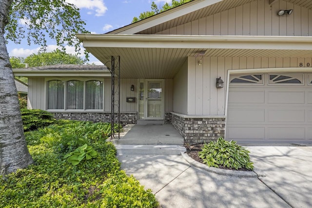 8074 48th Ave, Kenosha, WI 53142 - property entrance with stone siding and an attached garage