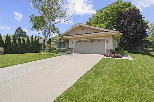8074 48th Ave, Kenosha, WI 53142 - view of front of house featuring an attached garage, a front lawn, driveway, and stone siding