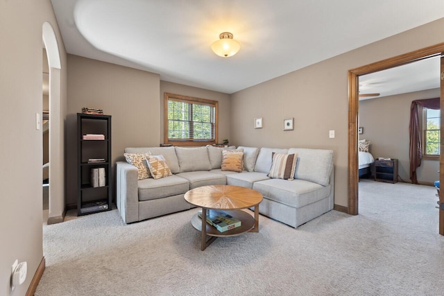 6507 Willow Ct, Waterford, WI 53185 - living room featuring carpet flooring, healthy amount of natural light, and arched walkways