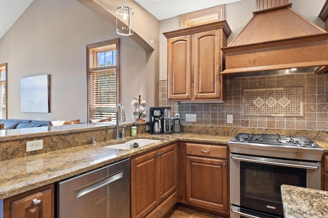 6507 Willow Ct, Waterford, WI 53185 - kitchen with appliances with stainless steel finishes, custom exhaust hood, light stone countertops, and tasteful backsplash
