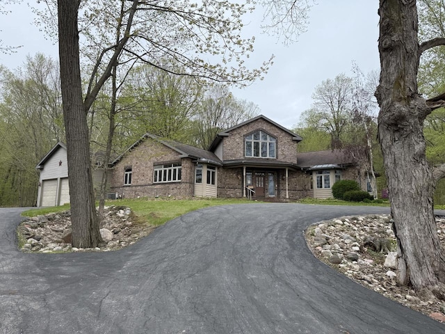 4228 County Hwy W, Valders, WI 54245 - view of front of house featuring driveway, brick siding, and a garage