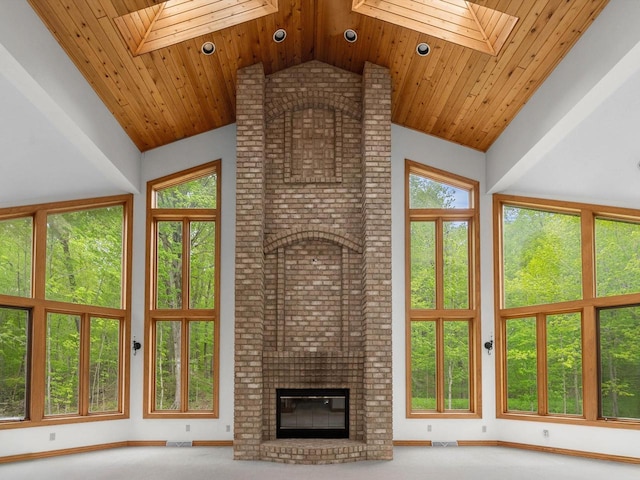 4228 County Hwy W, Valders, WI 54245 - unfurnished living room featuring a skylight, high vaulted ceiling, wood ceiling, and a fireplace