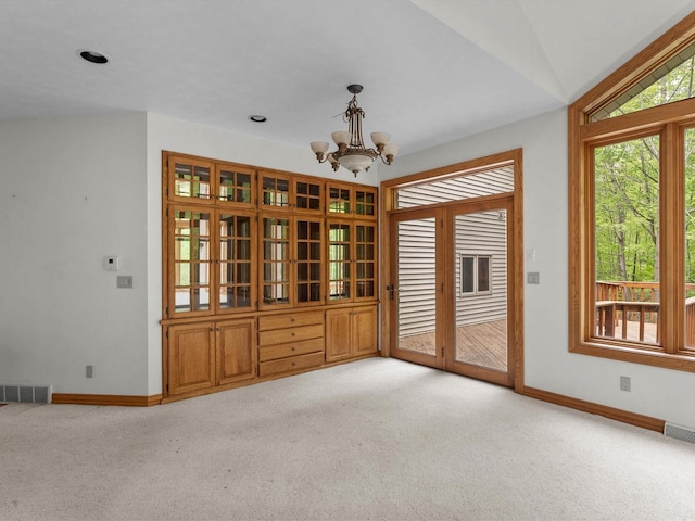 4228 County Hwy W, Valders, WI 54245 - unfurnished room featuring light colored carpet, a chandelier, and lofted ceiling