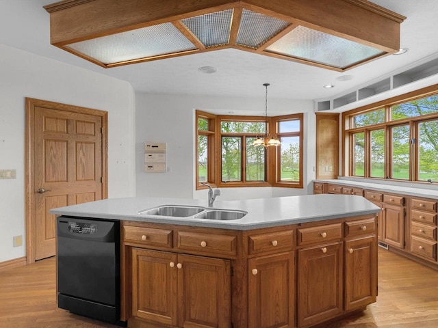 4228 County Hwy W, Valders, WI 54245 - kitchen featuring black dishwasher, light wood-style flooring, a chandelier, brown cabinets, and a center island
