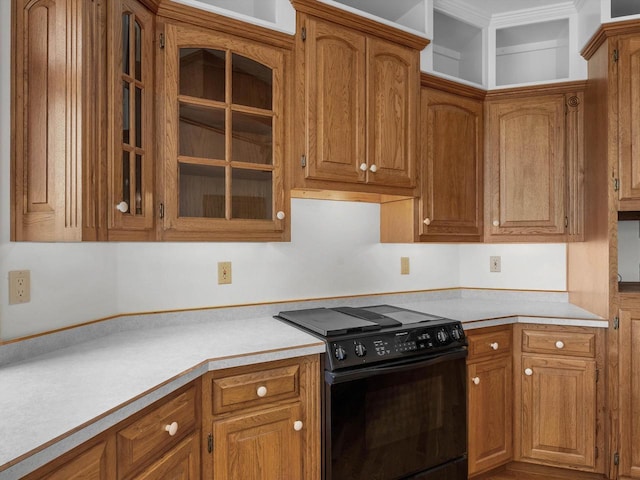 4228 County Hwy W, Valders, WI 54245 - kitchen with black range with electric stovetop, light countertops, and brown cabinets