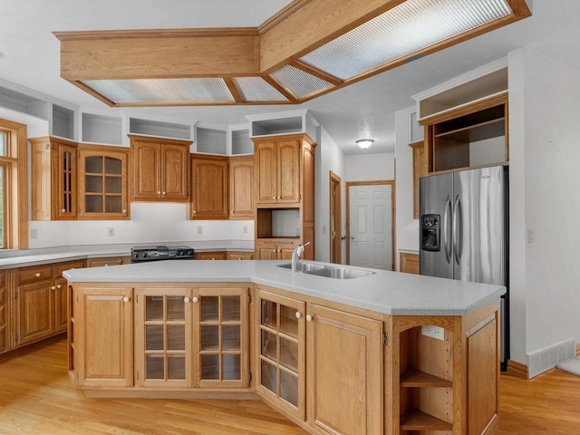 4228 County Hwy W, Valders, WI 54245 - kitchen with open shelves, light wood finished floors, light countertops, and a center island with sink