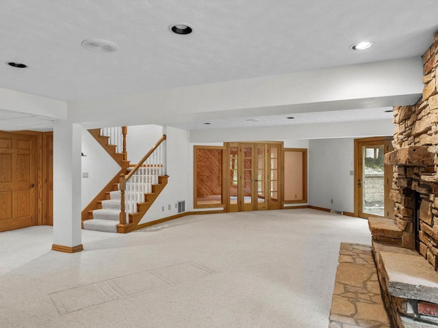 4228 County Hwy W, Valders, WI 54245 - unfurnished living room featuring stairway and a stone fireplace