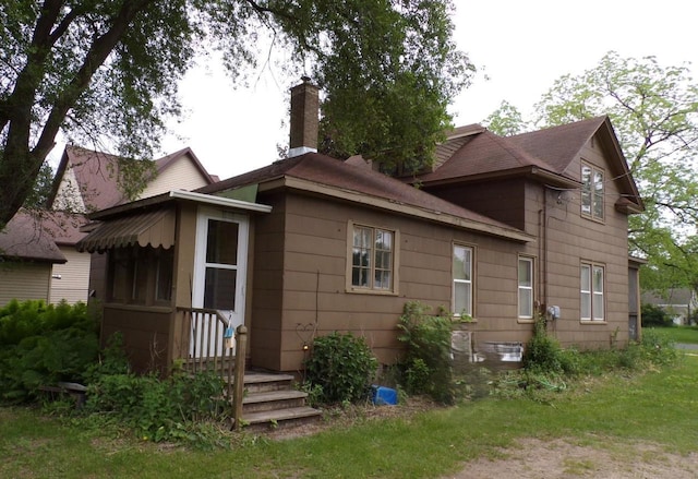 208 S Walker St, Wautoma, WI 54982 - back of property with a chimney and a shingled roof