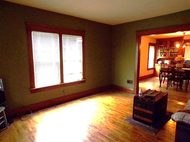 208 S Walker St, Wautoma, WI 54982 - living area with wood finished floors, plenty of natural light, and a chandelier