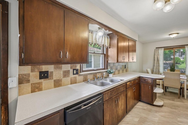 3838 N 78th St, Milwaukee, WI 53222 - kitchen with dishwashing machine, light countertops, tasteful backsplash, and a peninsula