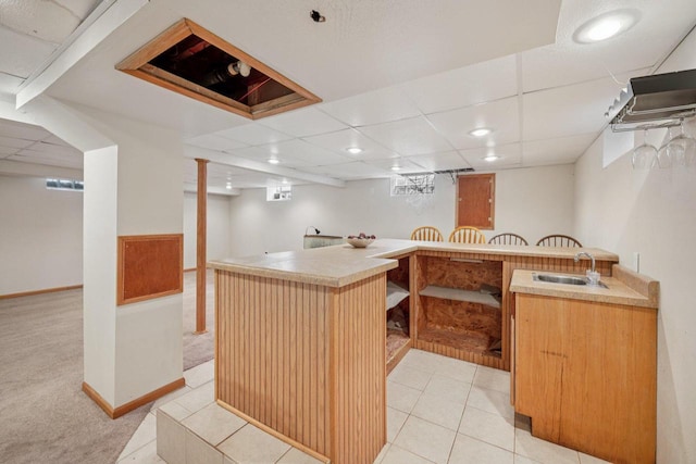 3838 N 78th St, Milwaukee, WI 53222 - kitchen featuring light carpet, recessed lighting, a kitchen breakfast bar, light countertops, and light tile patterned flooring