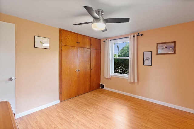 3716 County Rd Unit B, Mcfarland, WI 53558 - unfurnished bedroom featuring light wood finished floors, a closet, and a ceiling fan