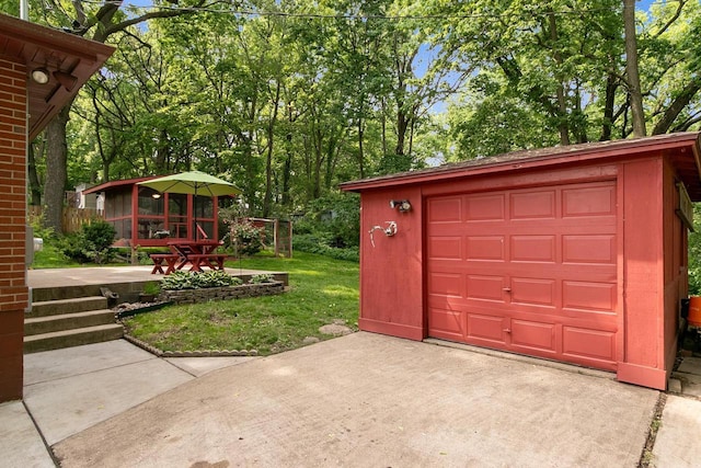 3716 County Rd Unit B, Mcfarland, WI 53558 - garage featuring driveway and view of wooded area