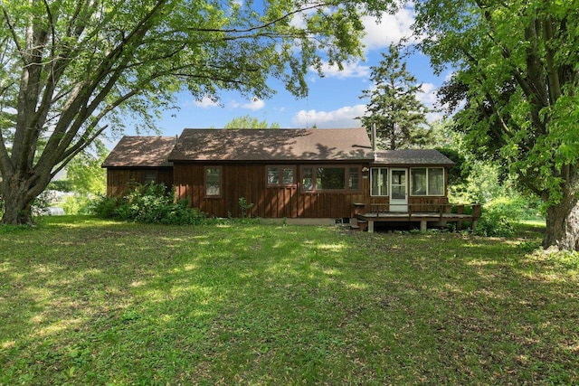 8950 Pine Ln, Fremont, WI 54940 - back of property featuring a sunroom and a lawn