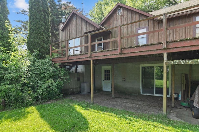 8950 Pine Ln, Fremont, WI 54940 - rear view of house featuring board and batten siding, a wooden deck, a yard, and a patio area