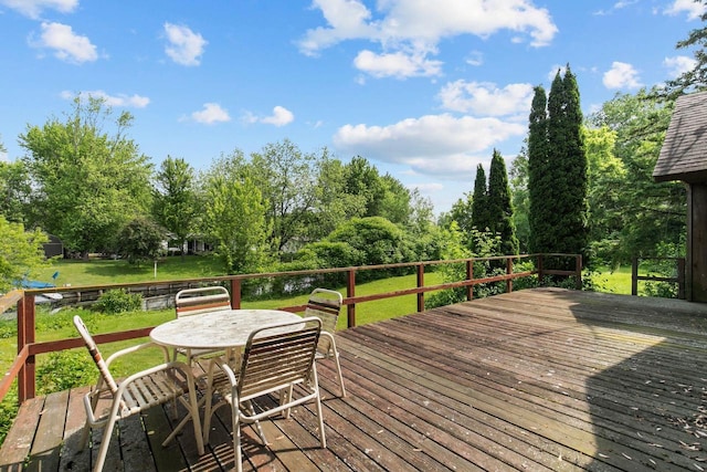 8950 Pine Ln, Fremont, WI 54940 - wooden terrace featuring a yard, outdoor dining space, and view of wooded area