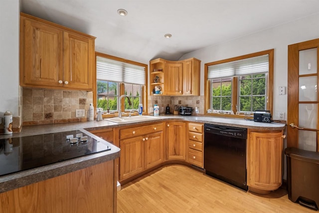 600 Forest Ave, Fond Du Lac, WI 54935 - kitchen with black appliances, healthy amount of natural light, backsplash, and light wood-style floors
