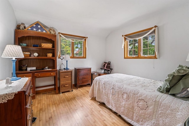 600 Forest Ave, Fond Du Lac, WI 54935 - bedroom featuring multiple windows, light wood-style flooring, and lofted ceiling
