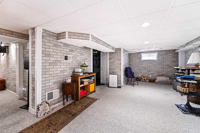 600 Forest Ave, Fond Du Lac, WI 54935 - below grade area with brick wall, a paneled ceiling, and carpet flooring