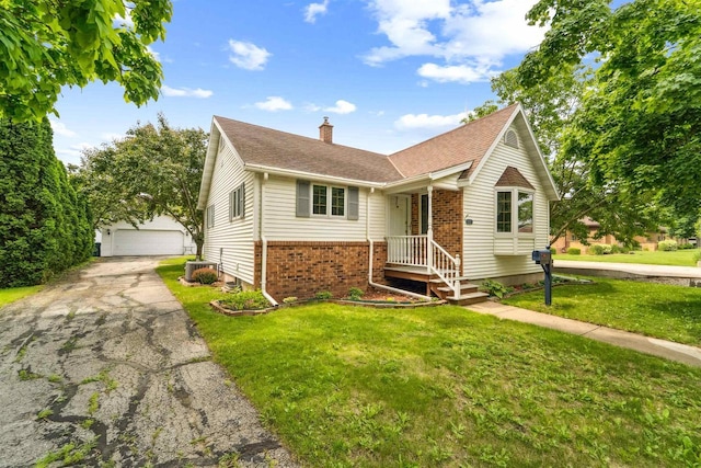 600 Forest Ave, Fond Du Lac, WI 54935 - view of front of home featuring brick siding, a chimney, an outdoor structure, a detached garage, and a front lawn