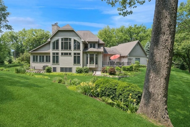 N1760 W Valley Park Rd, Lake Geneva, WI 53147 - rear view of house featuring a chimney and a yard