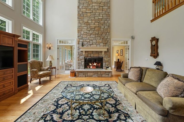 N1760 W Valley Park Rd, Lake Geneva, WI 53147 - living area featuring a high ceiling, a stone fireplace, and light wood finished floors