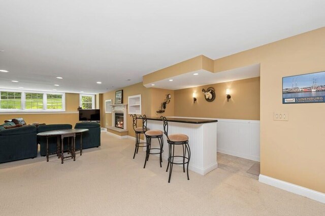 N1760 W Valley Park Rd, Lake Geneva, WI 53147 - bar featuring light colored carpet, recessed lighting, a warm lit fireplace, and a wainscoted wall