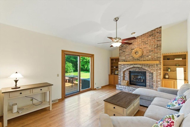 26 Maple Valley Ct, Madison, WI 53719 - living area with light wood-type flooring, a ceiling fan, vaulted ceiling, and a brick fireplace