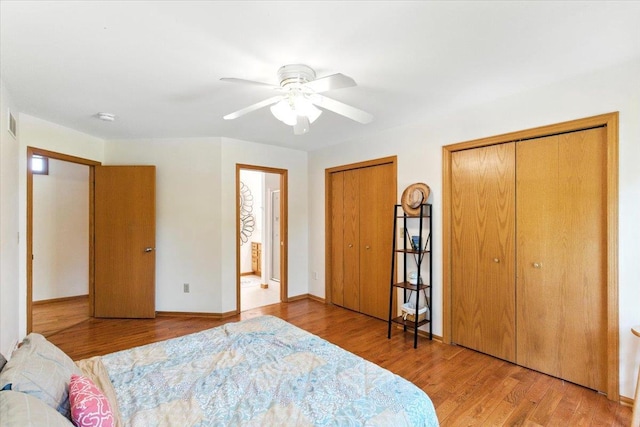 26 Maple Valley Ct, Madison, WI 53719 - bedroom with multiple closets, wood finished floors, and a ceiling fan