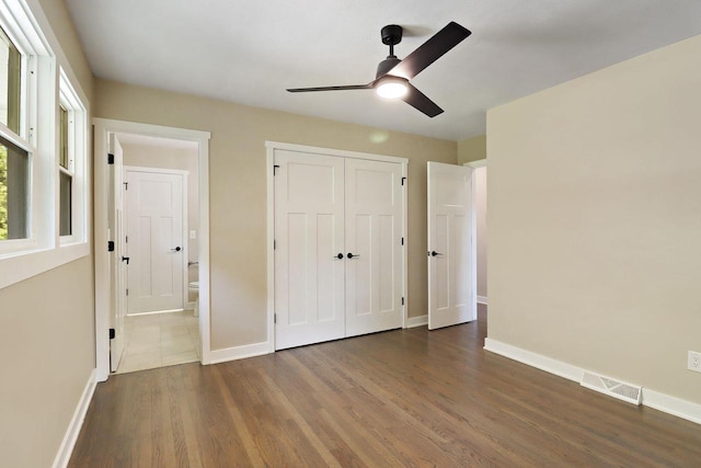 2336 128th St, Pleasant Prairie, WI 53158 - unfurnished bedroom with dark wood-style flooring, a closet, a ceiling fan, and connected bathroom