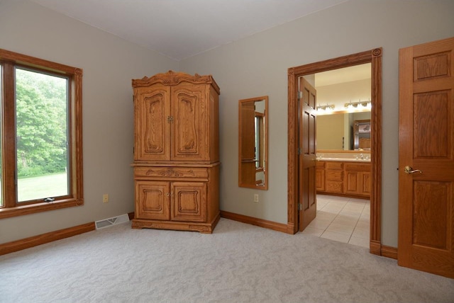 6200 County Road Tt, Marshall, WI 53559 - bedroom featuring light carpet, ensuite bathroom, and light tile patterned floors