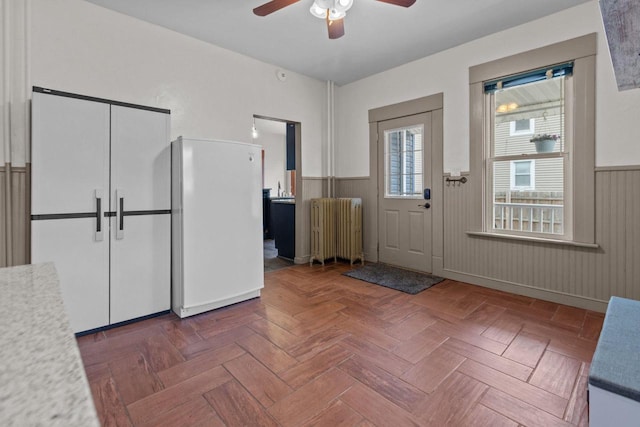 628 Broad St, Menasha, WI 54952 - entryway with radiator, wainscoting, and a ceiling fan