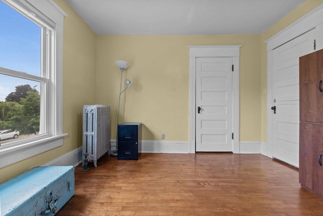 628 Broad St, Menasha, WI 54952 - spare room featuring radiator and wood finished floors
