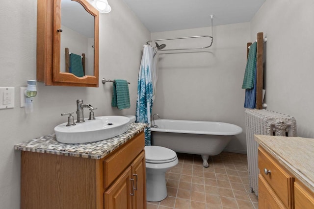 628 Broad St, Menasha, WI 54952 - bathroom featuring vanity, radiator heating unit, and tile patterned flooring