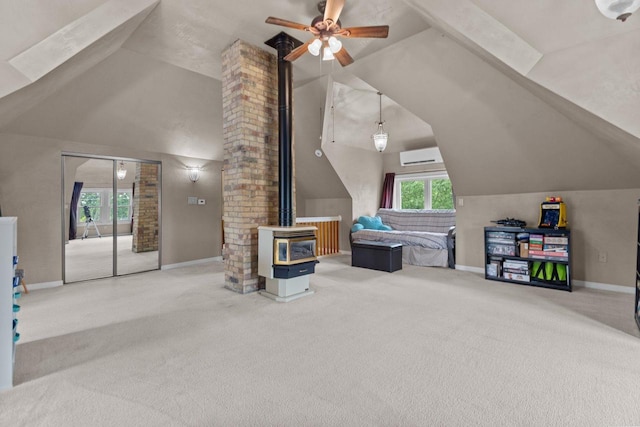 628 Broad St, Menasha, WI 54952 - additional living space featuring a wood stove, lofted ceiling, carpet, ceiling fan, and a wall mounted AC