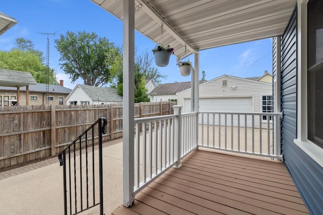 628 Broad St, Menasha, WI 54952 - wooden terrace featuring an outdoor structure and a detached garage