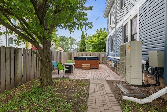 628 Broad St, Menasha, WI 54952 - fenced backyard featuring a hot tub and a patio area