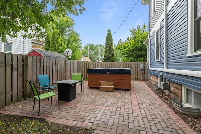 628 Broad St, Menasha, WI 54952 - fenced backyard with a hot tub, a patio, and a fire pit