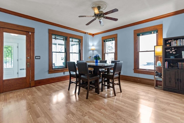 628 Broad St, Menasha, WI 54952 - dining space featuring light wood-type flooring, ornamental molding, and ceiling fan