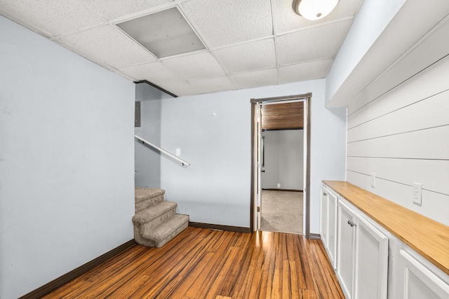 448 Wadleigh St, Stevens Point, WI 54481 - empty room with a drop ceiling, wood-type flooring, and stairway