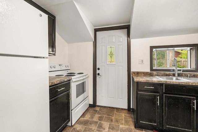 448 Wadleigh St, Stevens Point, WI 54481 - kitchen featuring white appliances, dark cabinetry, stone finish flooring, and dark countertops
