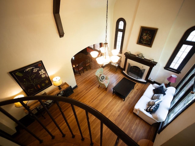 2544 N 91st St, Wauwatosa, WI 53226 - living room with arched walkways, a chandelier, wood finished floors, and a towering ceiling