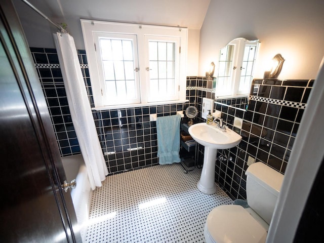 2544 N 91st St, Wauwatosa, WI 53226 - full bath featuring tile walls, healthy amount of natural light, a wainscoted wall, shower / bath combo, and tile patterned floors