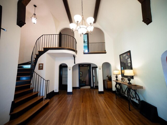2544 N 91st St, Wauwatosa, WI 53226 - entrance foyer featuring arched walkways, a chandelier, hardwood / wood-style floors, stairway, and a towering ceiling