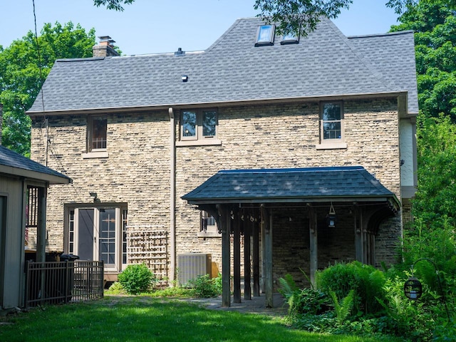 2544 N 91st St, Wauwatosa, WI 53226 - back of house featuring a chimney, a shingled roof, and a yard