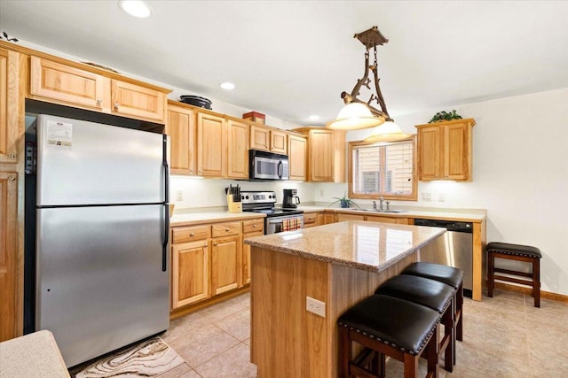 2015-1 S Czech Ct Unit 1201, Arkdale, WI 54613 - kitchen with appliances with stainless steel finishes, light tile patterned floors, a center island, light brown cabinetry, and a kitchen breakfast bar