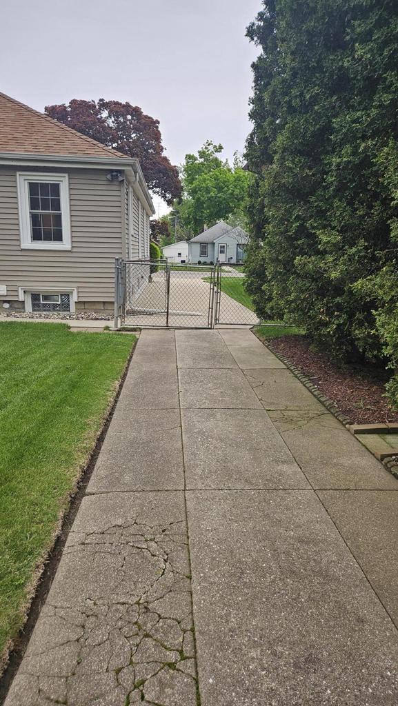 1518 Lathrop Ave, Racine, WI 53405 - view of home's exterior featuring a gate and a lawn