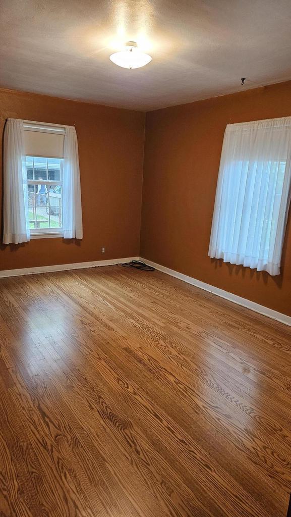 1518 Lathrop Ave, Racine, WI 53405 - empty room featuring wood finished floors and baseboards
